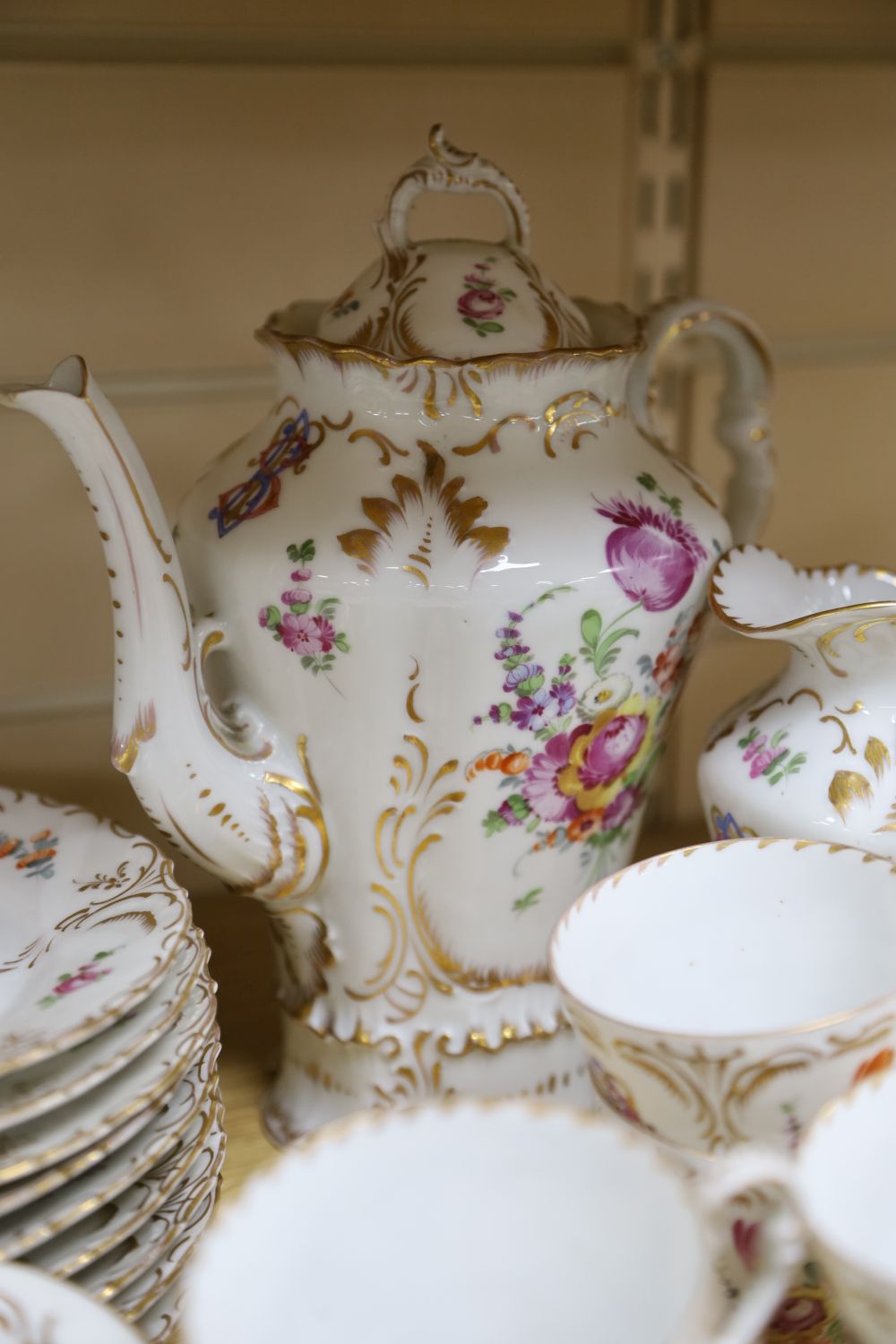 A 19th century Continental twenty nine piece gilt and floral coffee set, monogrammed, coffee pot 26cm